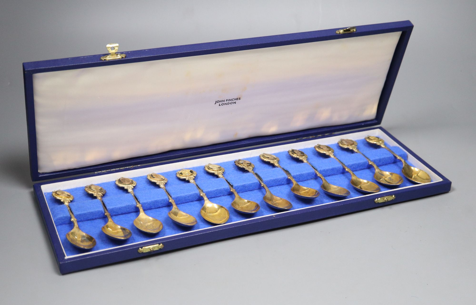 A set of The Twelve Roman silver gilt spoons, sculpted by David Cornell, one of a limited edition of 384, cased,
